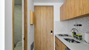 Una cocina moderna con armarios de madera, un lavamanos doble y un salpicadero de azulejos.