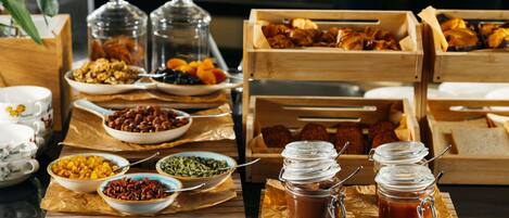 A breakfast buffet with various food items and condiments.
