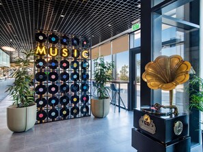 A wall with vinyl records and a large golden gramophone. - Ibis Tbilisi Airport (Tbilisi)
