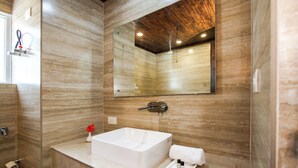 A modern bathroom with a large rectangular sink, a mirror above it, and a wooden ceiling. - Elysian Woods New Devidayar (Manali)