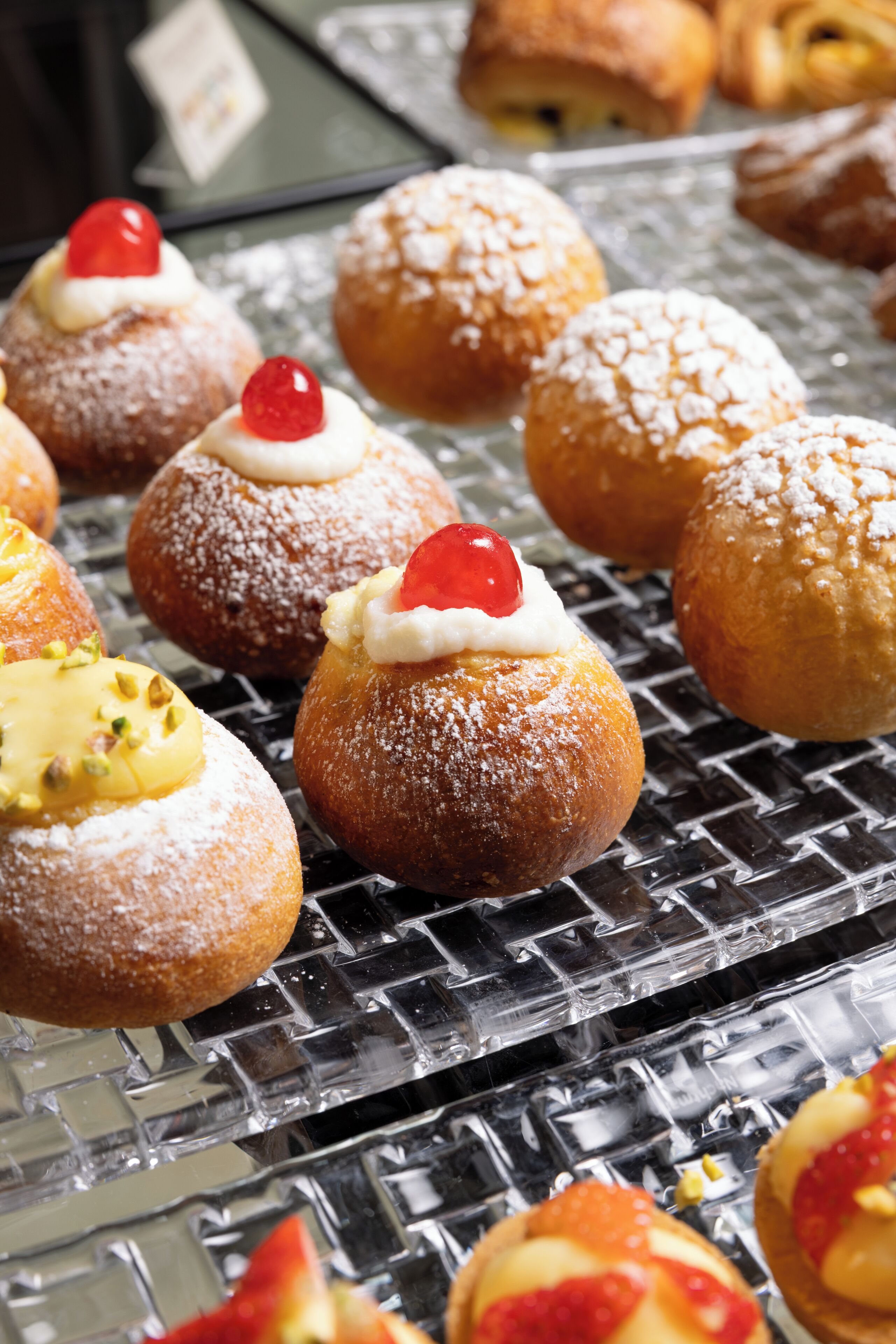 A display of various pastries on a metallic tray.