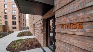 Een modern gebouw met een bakstenen gevel en de tekst 'KINGS' duidelijk zichtbaar.