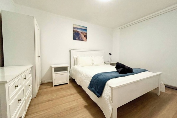 Queen bed master bedroom with ample dresser and wardrobe