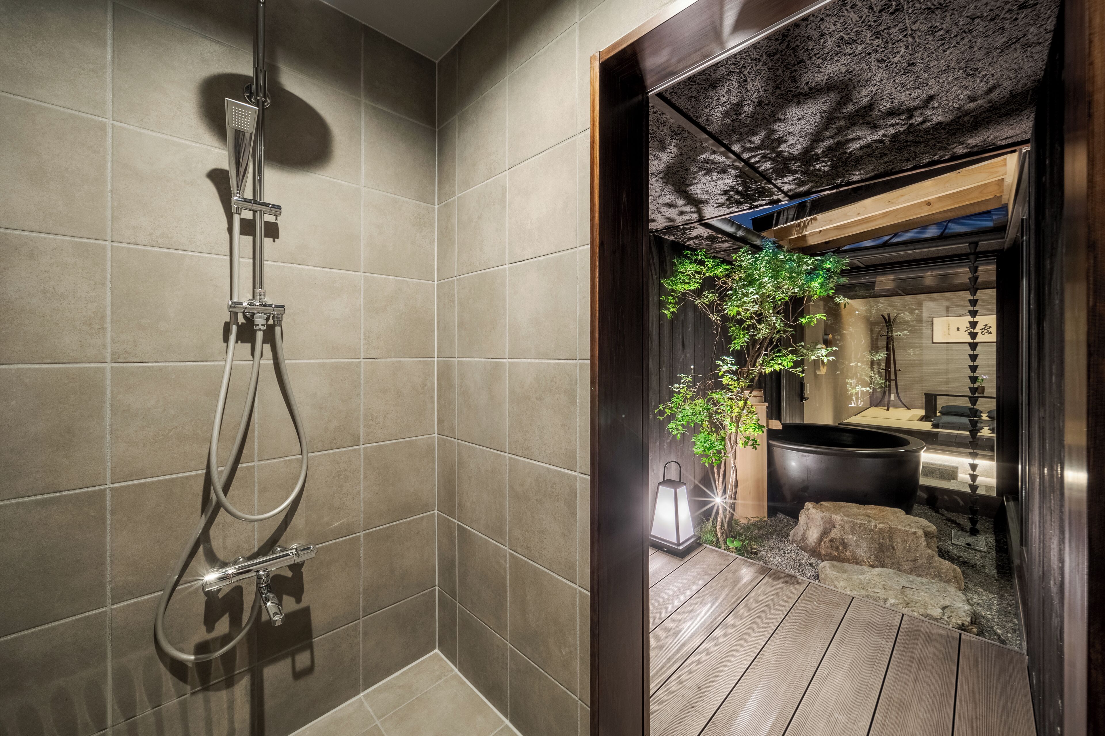 A modern bathroom with a shower, tiled walls, and a wooden floor.