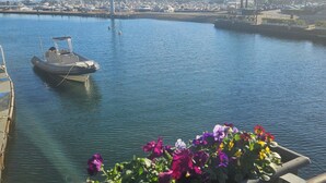 A marina with boats, a flower planter, and a clear sky. - Rapallo 2-bed Apt, Sleeps 5 With Hot Tub (Rapallo)