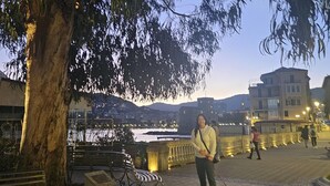 A tree-lined walkway with benches, a dog, and a river in the background. - Rapallo 2-bed Apt, Sleeps 5 With Hot Tub (Rapallo)