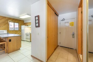 A kitchen with a microwave, stove, and wooden cabinets.