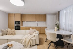 A modern kitchen with wooden cabinets, a built-in oven, and a white countertop.