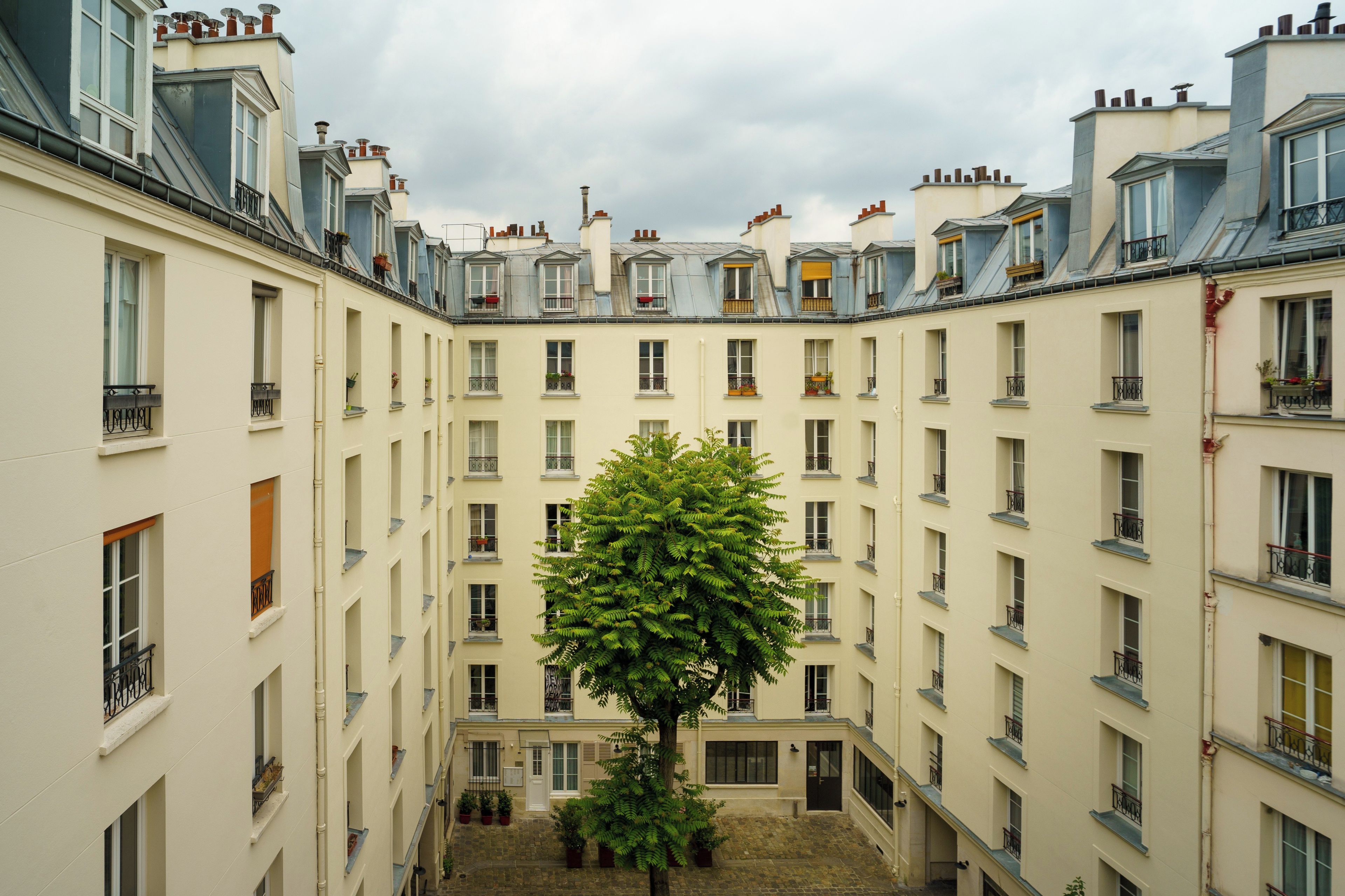 A courtyard surrounded by multi-story buildings with balconies and windows.