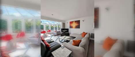 A modern living room with a sofa set, a coffee table, and a television.