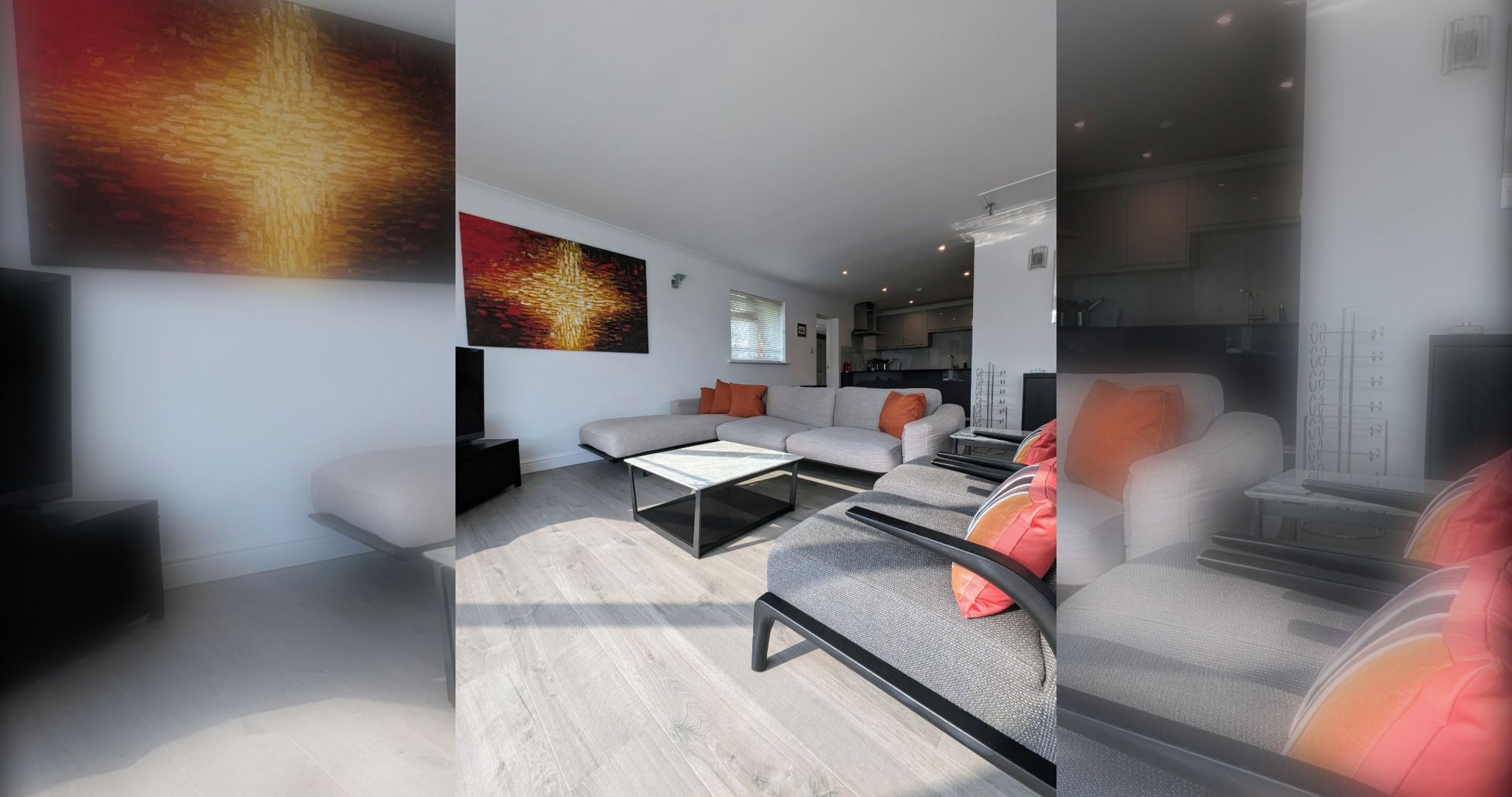 Ein modernes Wohnzimmer mit Sofa, Couchtisch und Fernseher.