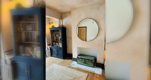 A room with a bookshelf, a fireplace, and a round mirror on the wall. - Stylish 4-Bedroom House in Vibrant Walthamstow (Greater London)
