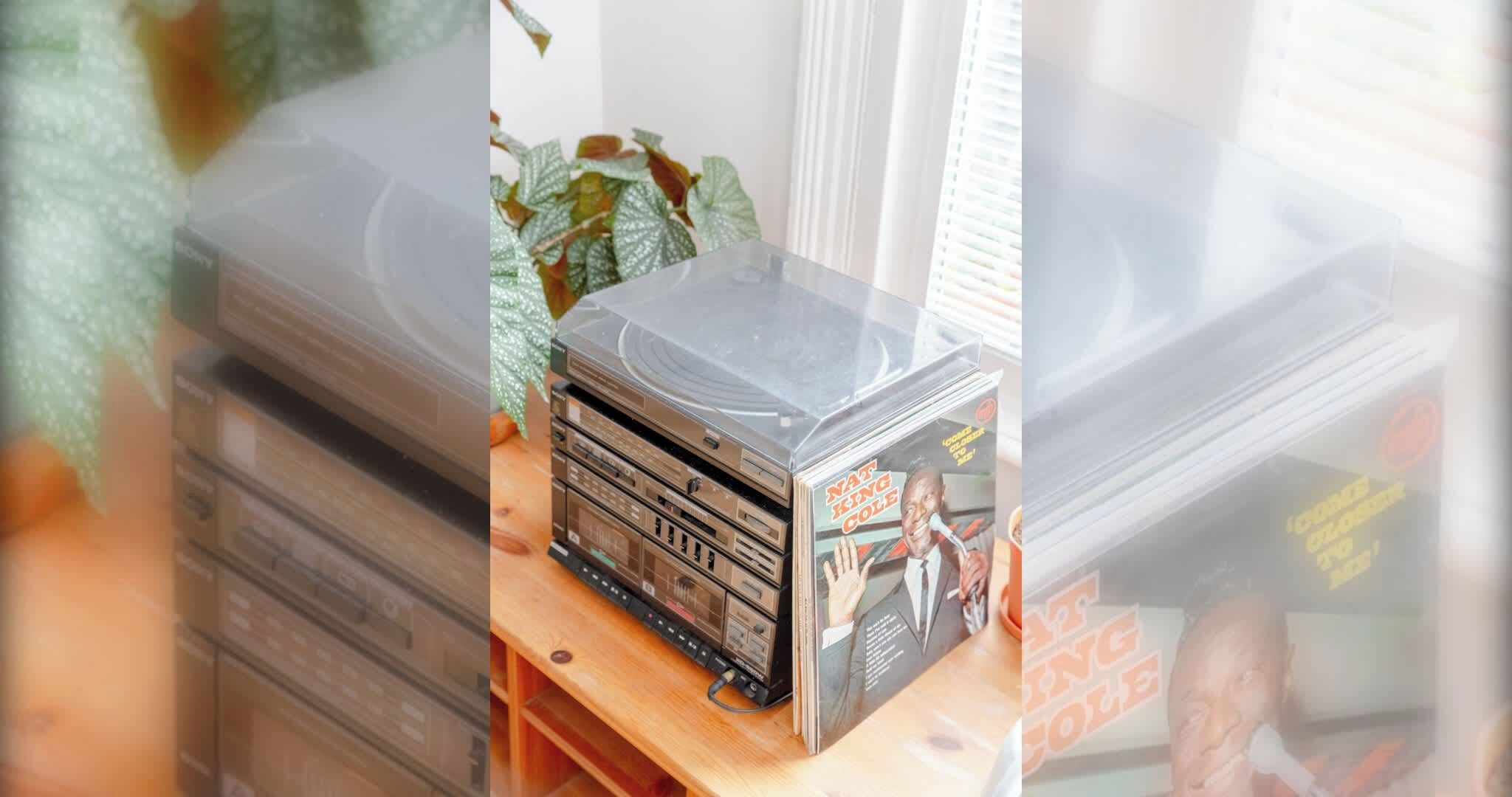 A stack of cassette tapes on a wooden surface.