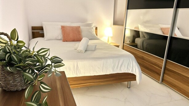 A modern hotel room with a neatly made bed, a large mirror, and a potted plant. - St.Julian's Brand New apartments (1)

Walking distance to St Julians Paceville

 (Swieqi)