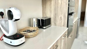 A modern kitchen with a coffee machine, toaster, and wicker basket on the counter. - St.Julian's Brand New apartments (1)

Walking distance to St Julians Paceville

 (Swieqi)