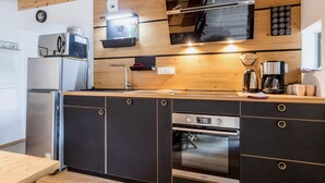 A modern kitchen with a built-in oven, a microwave, and a coffee maker.