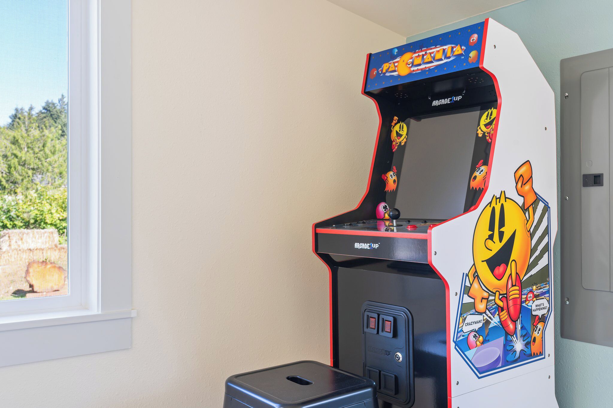 An arcade machine with a cartoon character design, a coin slot, and buttons.