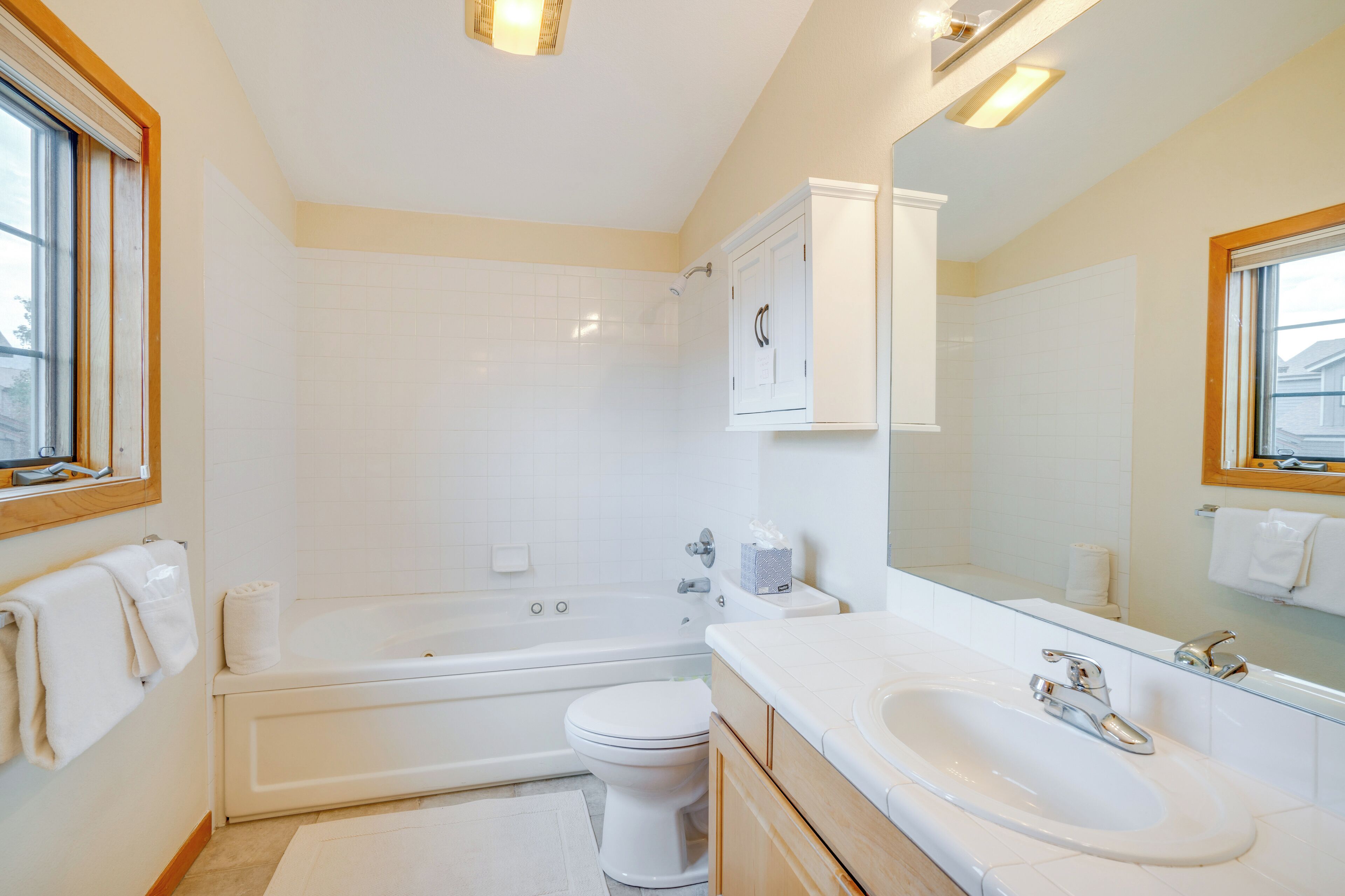 A modern bathroom with a bathtub, toilet, and sink.