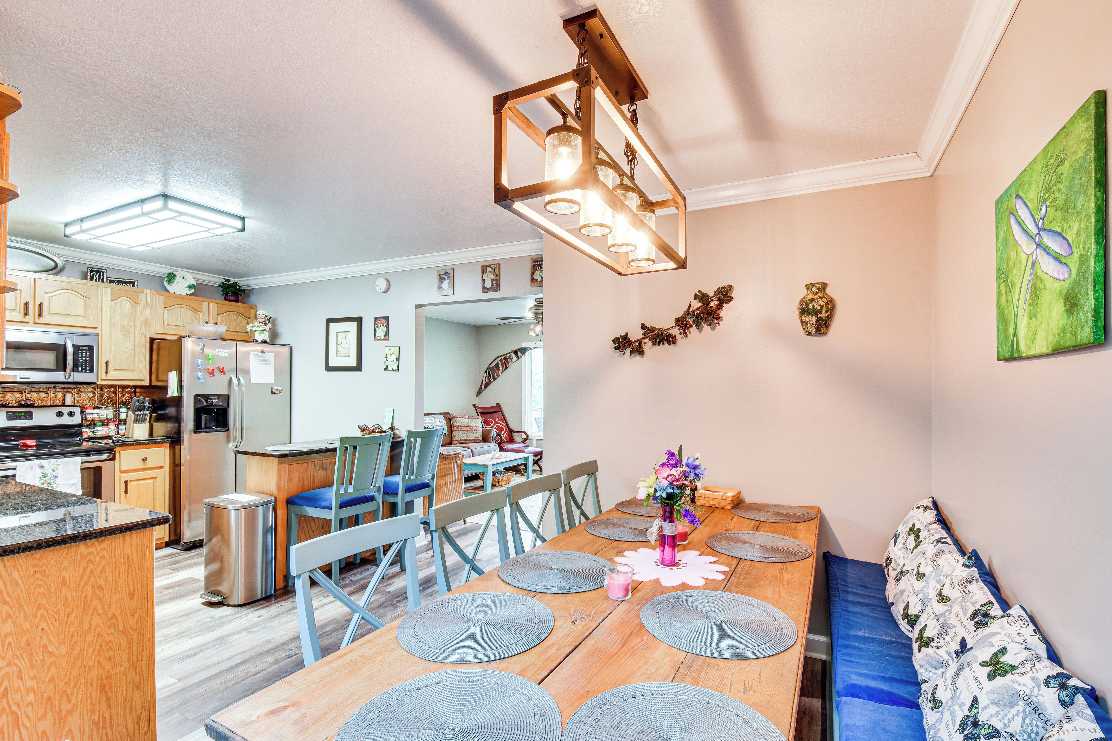 A dining area with a wooden table, blue chairs, and a bench.