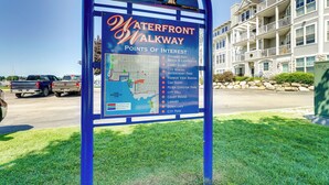 A sign for the Waterfront Walkway listing points of interest like Stearns Park, Beach & Lighthouse, and City Hall.