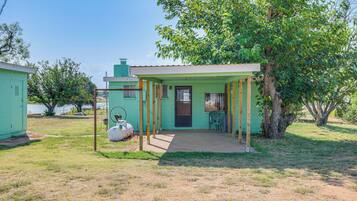 Guests can enter this charming single-story building through the front door, which leads to a cozy porch area with a window.