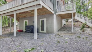 A two-story house with a covered deck and a staircase leading to the upper level. - Treasure Lake Home w/ Deck: Walk to Bimini Lake! (DuBois)