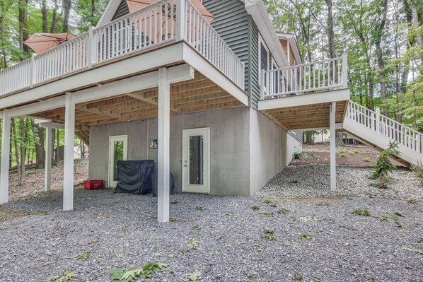 A two-story house with a covered deck and a staircase leading to the upper level. - Treasure Lake Home w/ Deck: Walk to Bimini Lake! (DuBois)