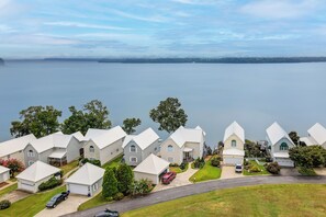 A residential area with houses, a road, and a body of water in the background. - Waterfront Bliss: Wheeler Lake Retreat w/ Dock! (Athens)