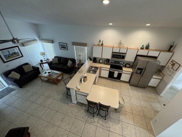 A compact living space with a kitchenette, a dining area, and a seating area.