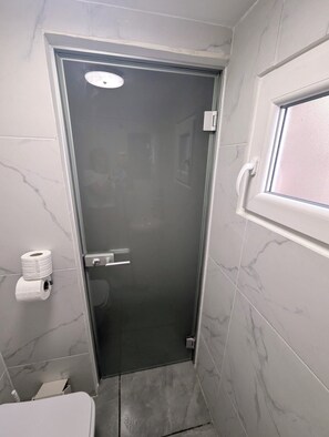 Shower, towels, soap, toilet paper