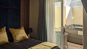 A bedroom with a large bed, a nightstand, a lamp, and a view of a balcony with a pool. - Domus Boutique Hotel (Rabat)