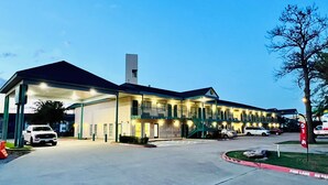 A motel with a gas station, multiple parking spaces, and a fire lane. - Rodeway Inn Garland Harbor Point (Garland)