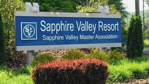 Ein Schild für Sapphire Valley Resort mit Logo, Name und Verbandsinformationen.