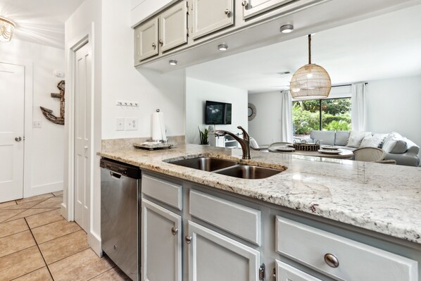 A modern kitchen with granite countertops, stainless steel appliances, and a large island.