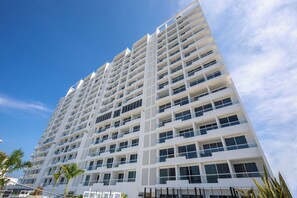 Stylish high-rise hotel with a grid-like facade and balconies.