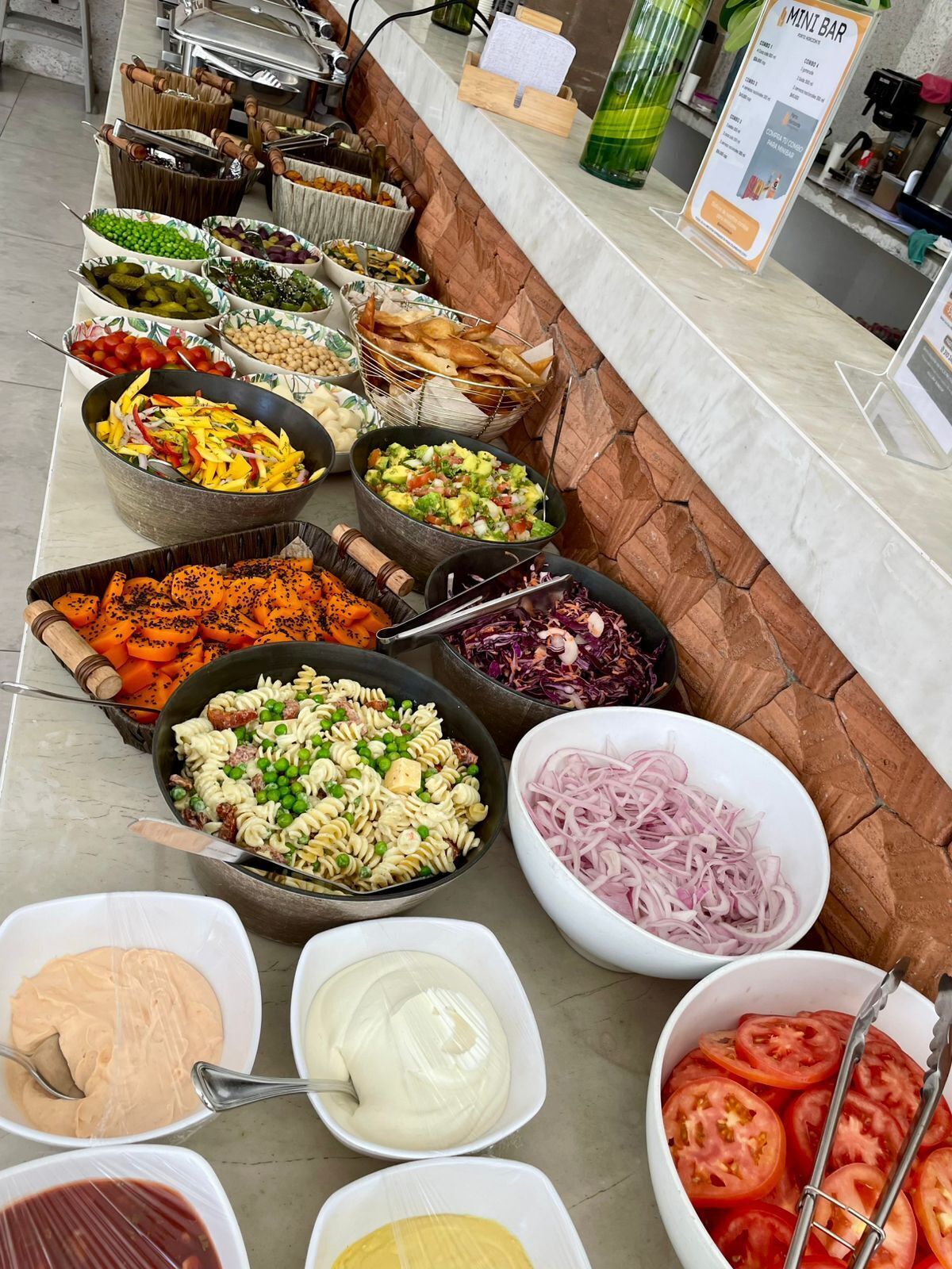 A buffet with various food items and condiments.
