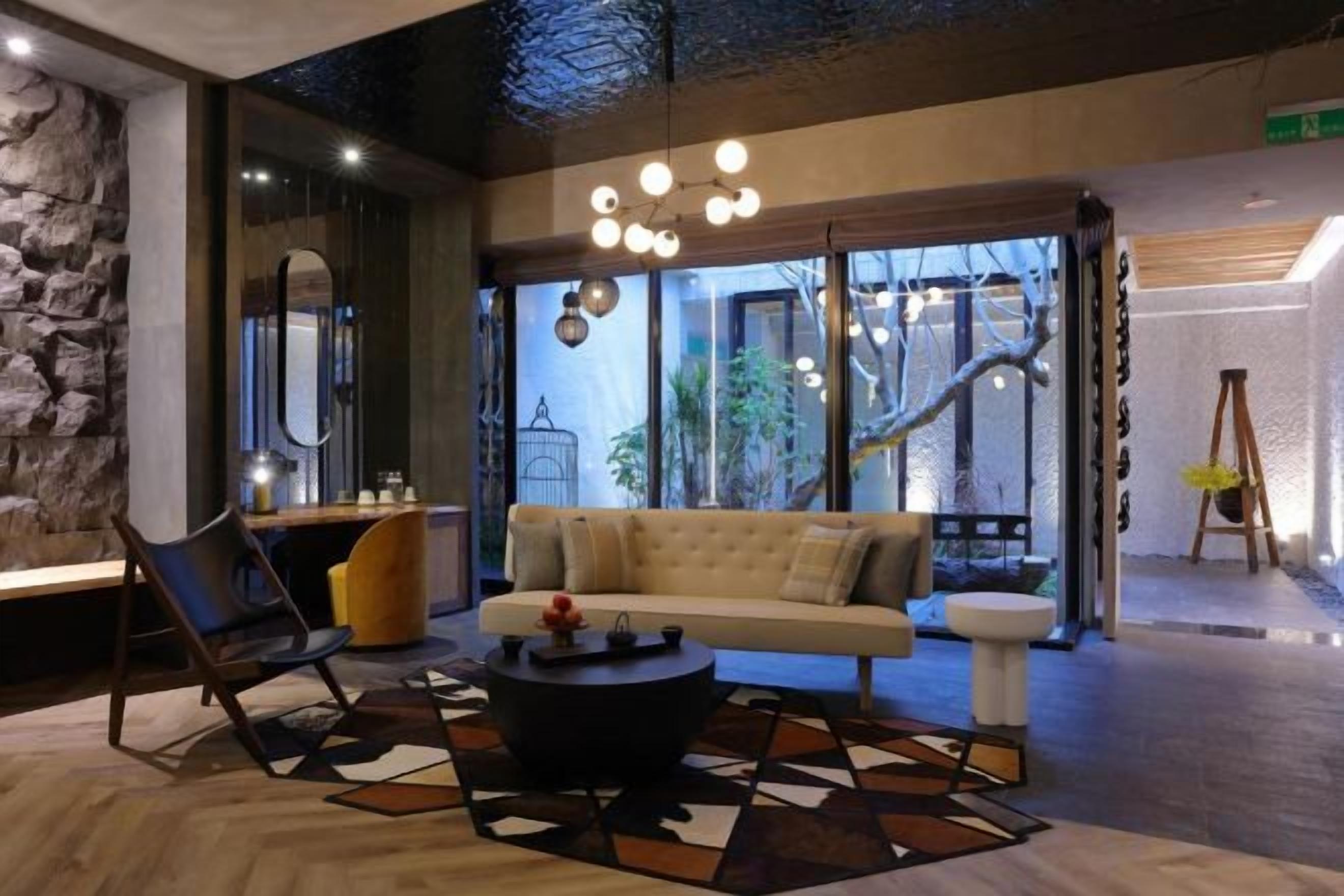 A modern interior with a sofa, coffee table, and a stone accent wall.