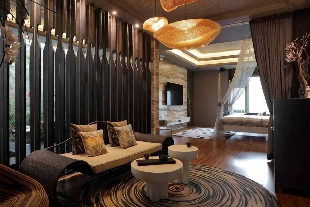 A modern living room with a sofa, a coffee table, and a fireplace.
