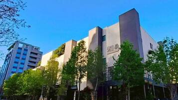 A modern building with a prominent entrance and a sign above it.