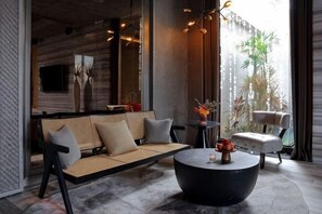 A modern interior with a sofa, round coffee table, and a chair.