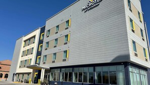 A modern hotel building with a flat facade, large windows, and a sign reading "MICROTEL BY WYNDHAM". - Microtel Inn & Suites By Wyndham Amarillo West (Amarillo)