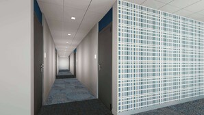 A corridor with patterned carpet, white walls, and a blue and white partition. - Microtel Inn & Suites By Wyndham Amarillo West (Amarillo)