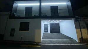 A two-story building with a flat roof, large windows, and a covered entrance. - The Rock Hostel (Ponta Delgada)