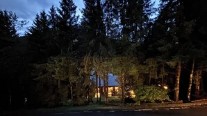 A house surrounded by tall trees at dusk. - Wuthering Heights Apartment, lovely apartment at the foot of the ski slopes (Angolo Terme)