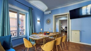 A dining area with a round table, yellow chairs, and a view of the outside balcony. - Spacious dwelling between Vatican and Center [3 bedrooms, 3 baths] (Roma)