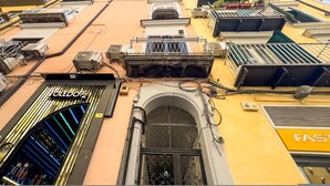 A building with multiple balconies, a visible storefront with the name "LOFELDOZ," and a section labeled "FAST." - Santa Patrizia a Chiaia Apartment - Terra (Naples)