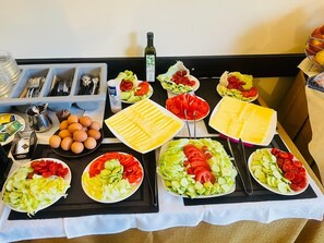 A buffet table with various food items including eggs, cheese, and salads. - HOTEL RAFFAELLO VENICE (Spinea)