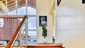 A wooden staircase with metal railings leading to a balcony. - Lookout sirwa
 (Naivasha)