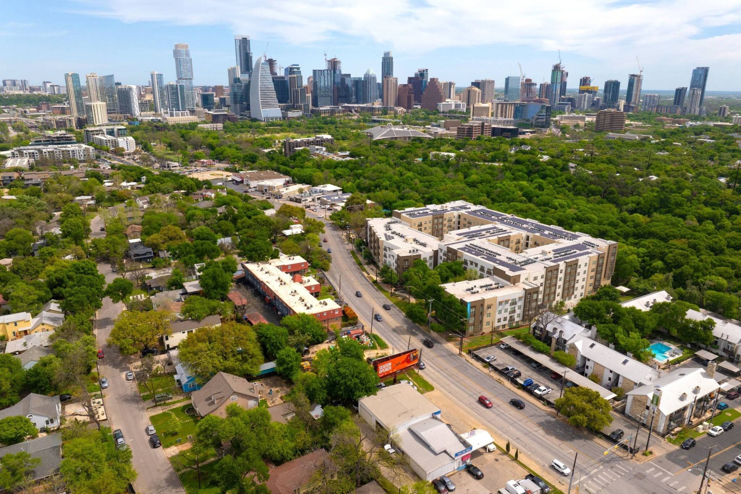 An aerial view of a cityscape with a mix of high-rise buildings and residential areas.
