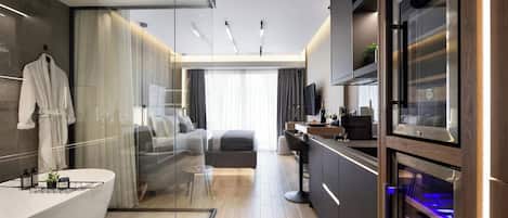 A modern bathroom with a large bathtub, a glass shower enclosure, and a vanity with a built-in sink.